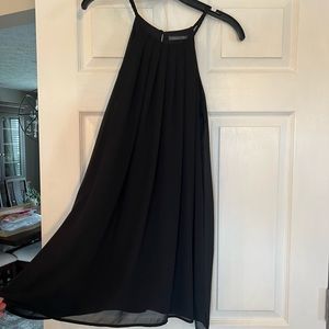 Black swing style dress. Sheer material over lining. Size small.